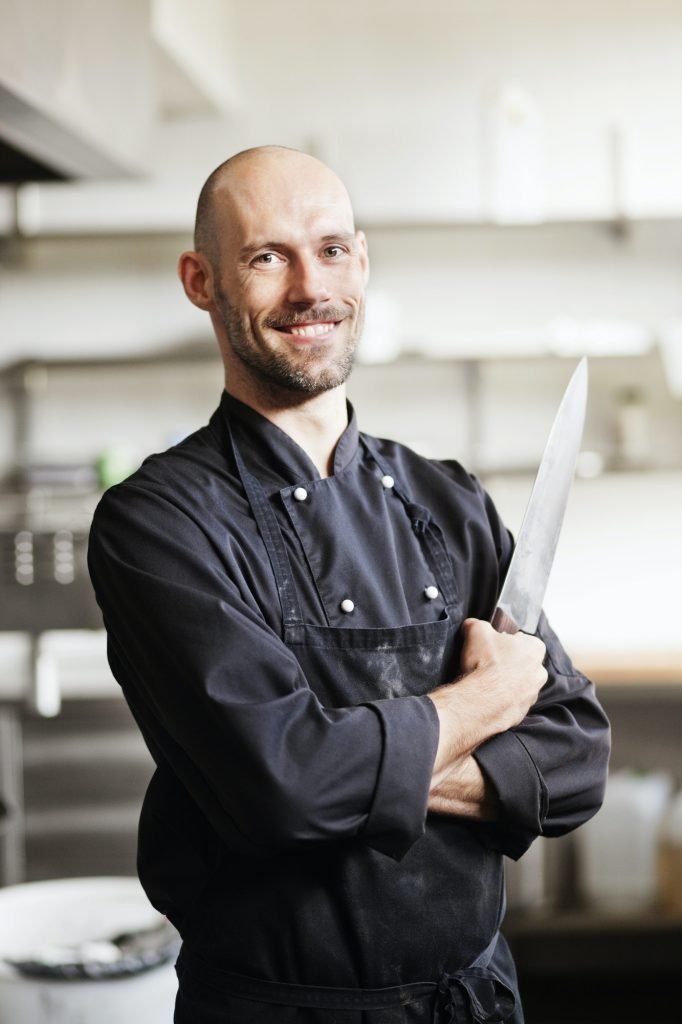 Portrait of knifesmith in kitchen